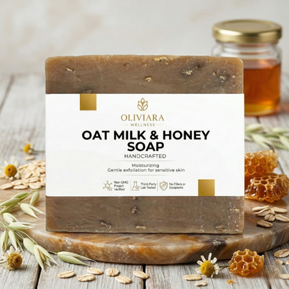 Oat milk and honey soap bar with Oliviara branding on a wooden surface with honey and oats.